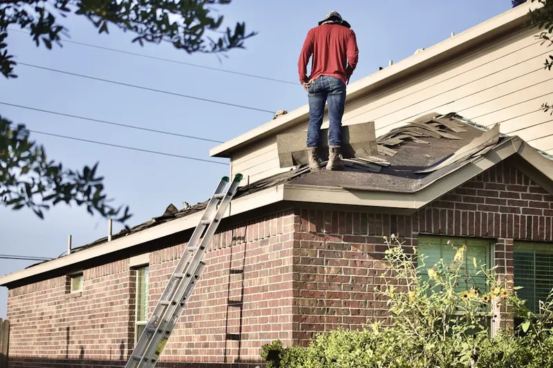 Professional roofer working on a residential roof in Bank Lick